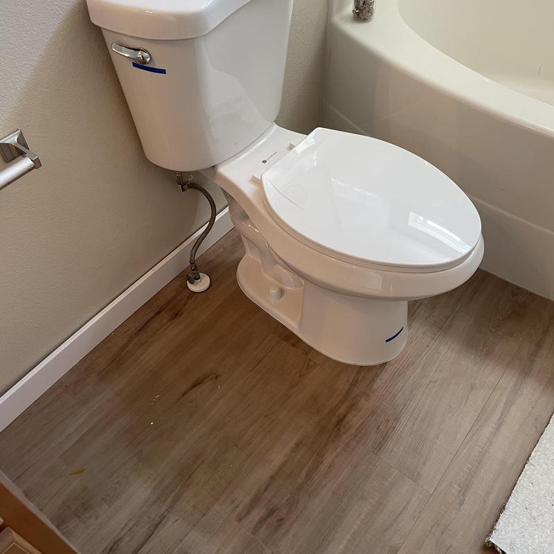 Customer supplied toilet installed and sealed to floor