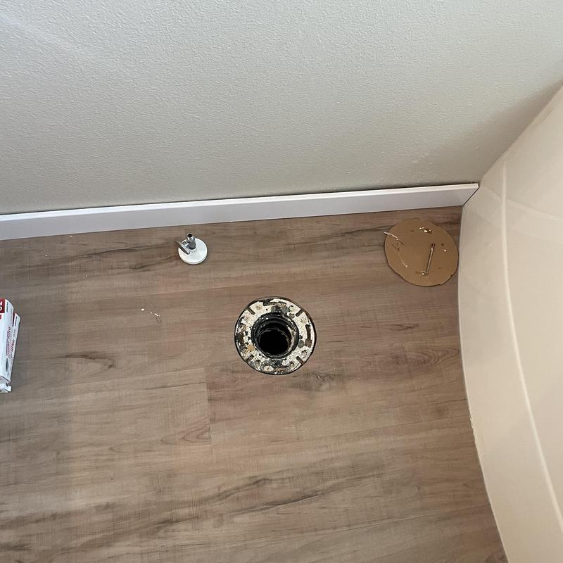 Toilet flange on wood floor awaiting installation