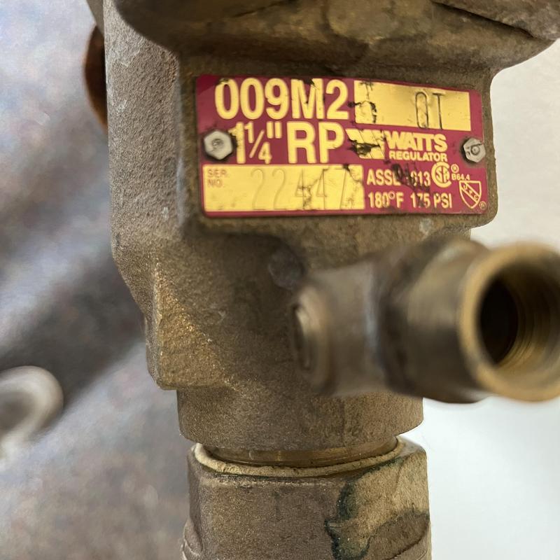 Backflow preventer valve with label close-up Backflow preventer valve with label close-up
