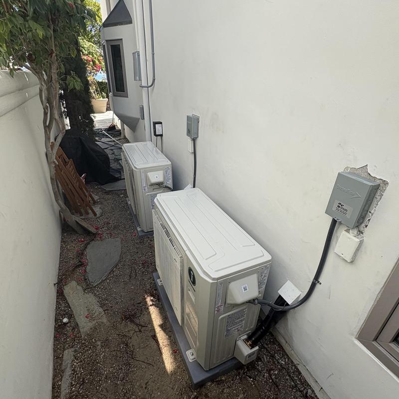 Multi mini split heat pump outdoor units installed side yard Multi mini split heat pump outdoor units installed side yard