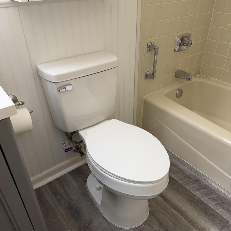 Toilet installation with white ceramic toilet in bathroom Toilet installation with white ceramic toilet in bathroom