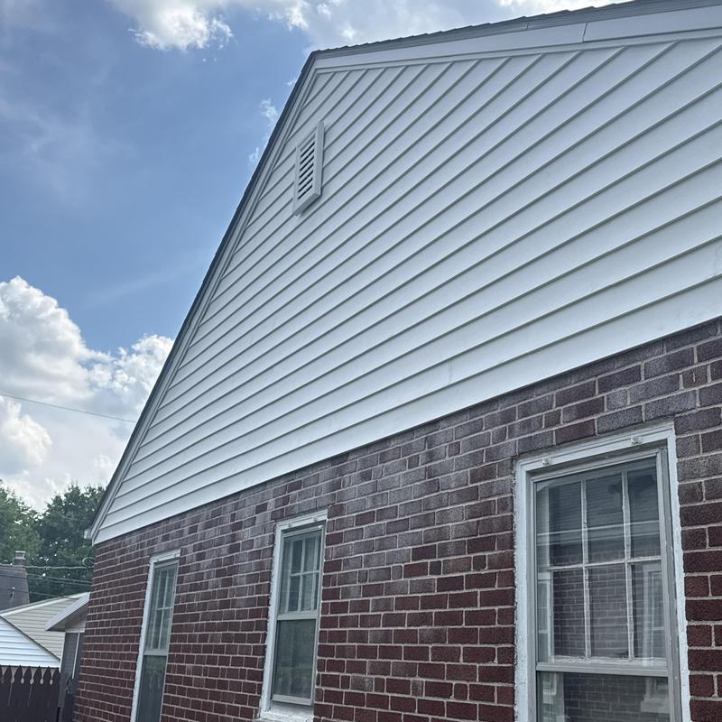 Vinyl siding installation on brick and gable wall Vinyl siding installation on brick and gable wall