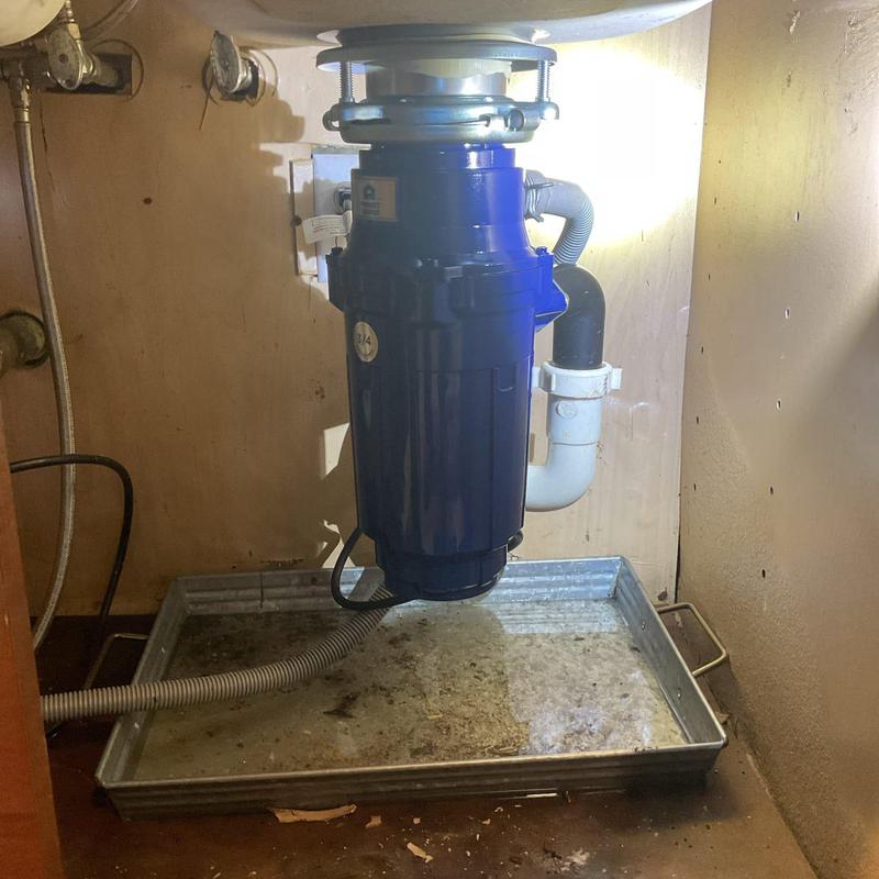 Garbage disposal unit installed under kitchen sink