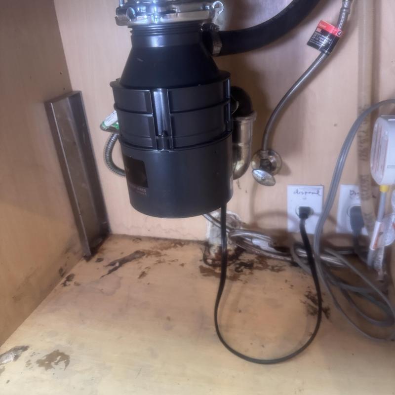 Garbage disposal unit and under-sink plumbing installation