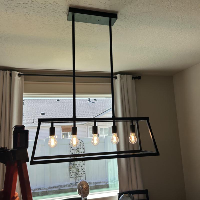 Dining room light fixture installation with exposed bulbs