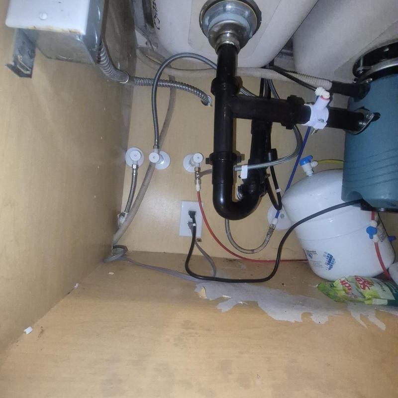 Kitchen sink drain and water lines under cabinet