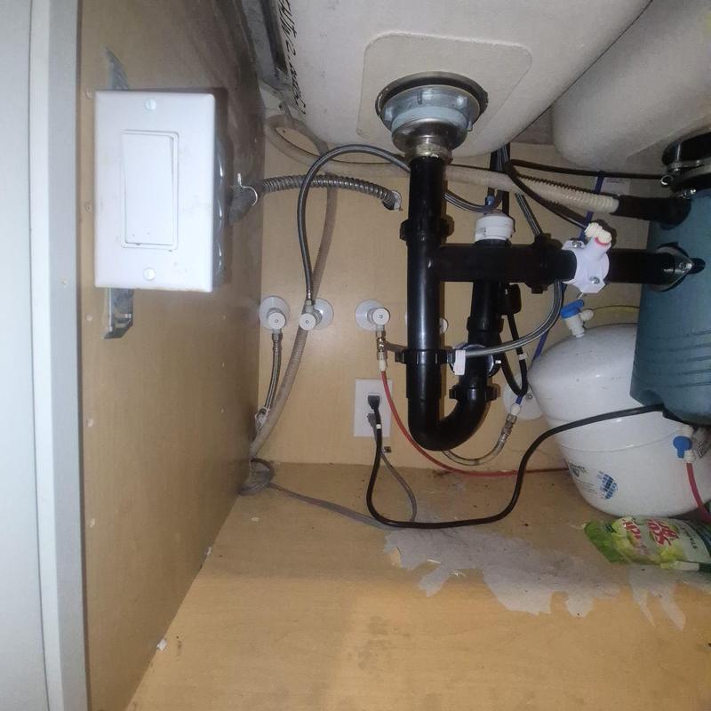 Kitchen sink plumbing with black PVC drain pipes