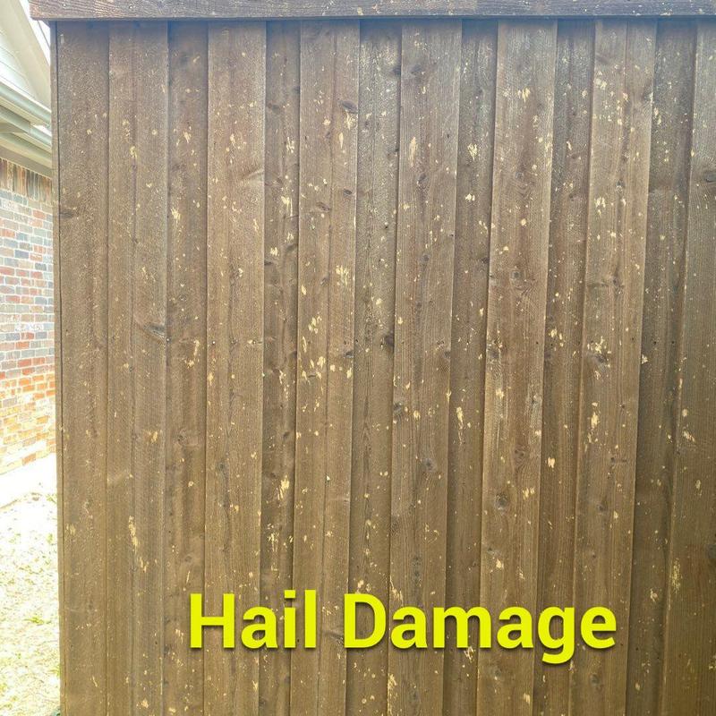 Wood fence with hail damage spots