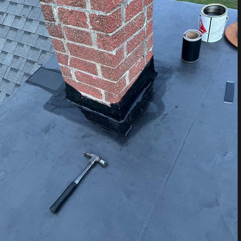 Flat roof chimney flashing with tools and sealant Flat roof chimney flashing with tools and sealant