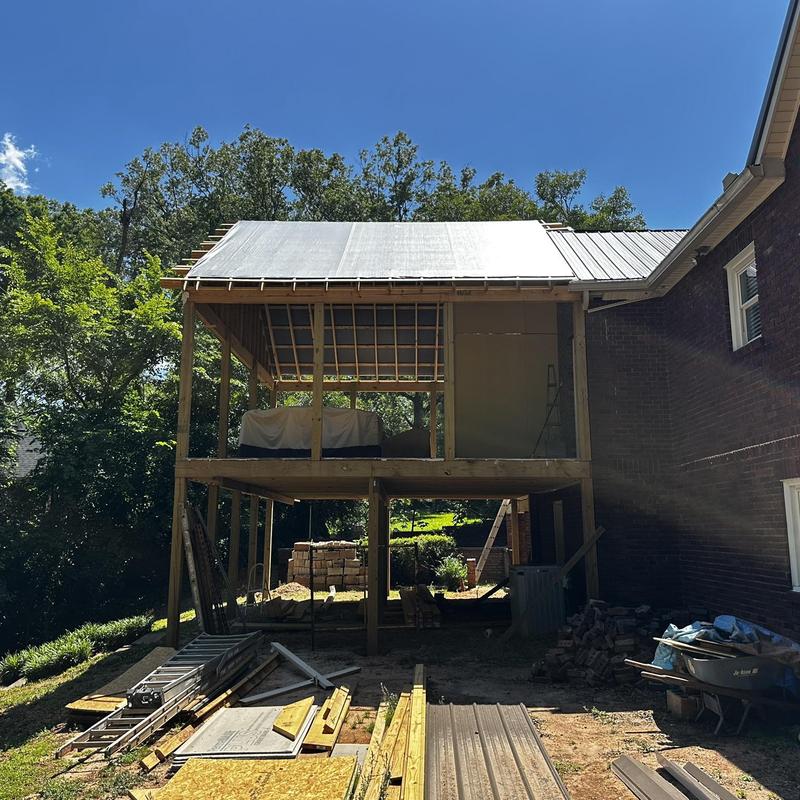 Metal roof installation on home porch frame Metal roof installation on home porch frame