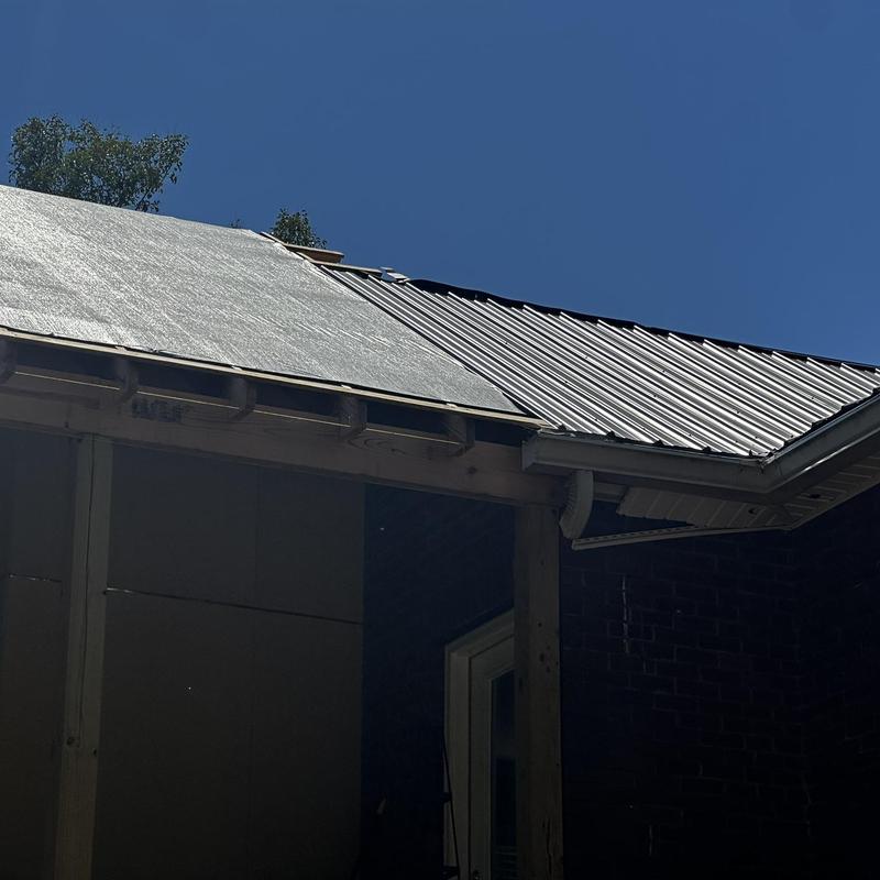 Metal roof installation on home porch after storm damage Metal roof installation on home porch after storm damage