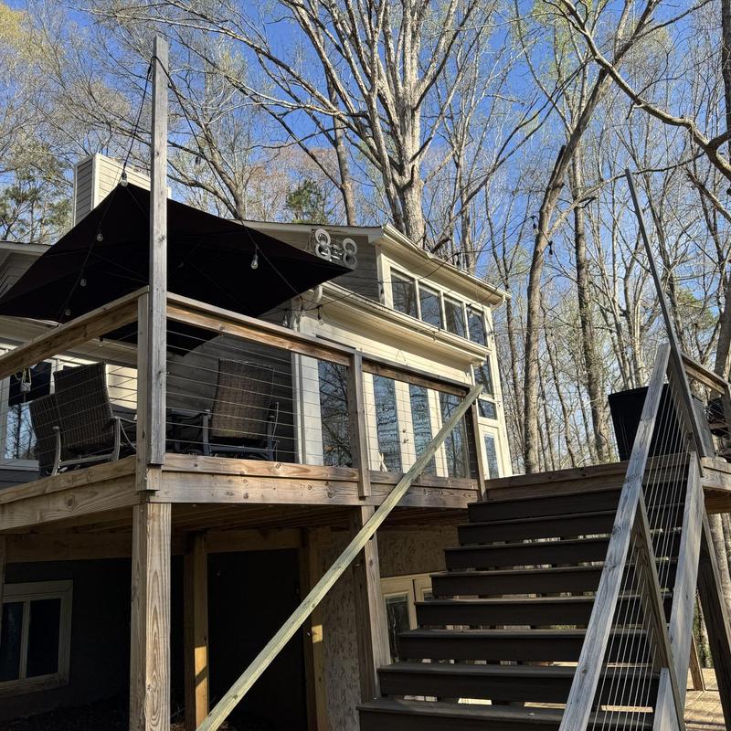 Wooden deck and railing with outdoor furniture and umbrella Wooden deck and railing with outdoor furniture and umbrella