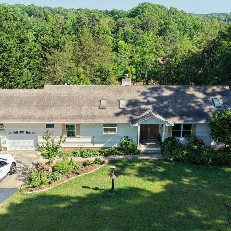Asphalt shingle roof on residential home with landscaping Asphalt shingle roof on residential home with landscaping