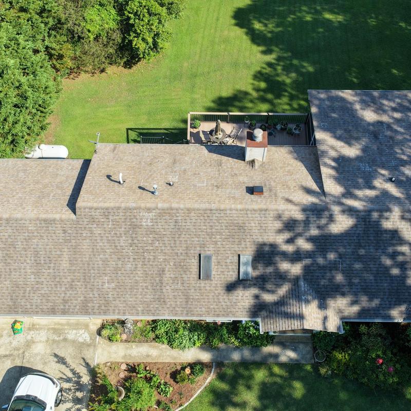 Asphalt shingle roof with hail damage marks visible Asphalt shingle roof with hail damage marks visible