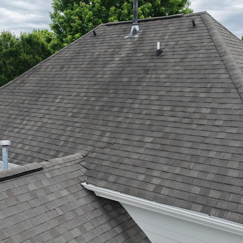 Asphalt shingle roof with vent pipes and gutters