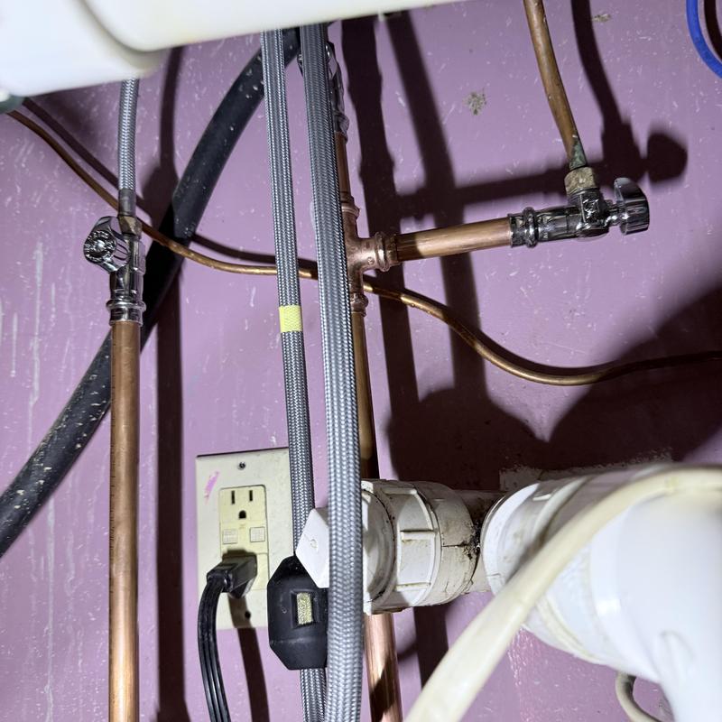 Emergency shut off valves and plumbing pipes under sink