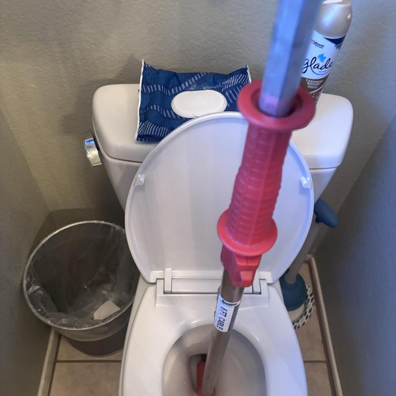 Toilet auger inside clogged toilet bowl