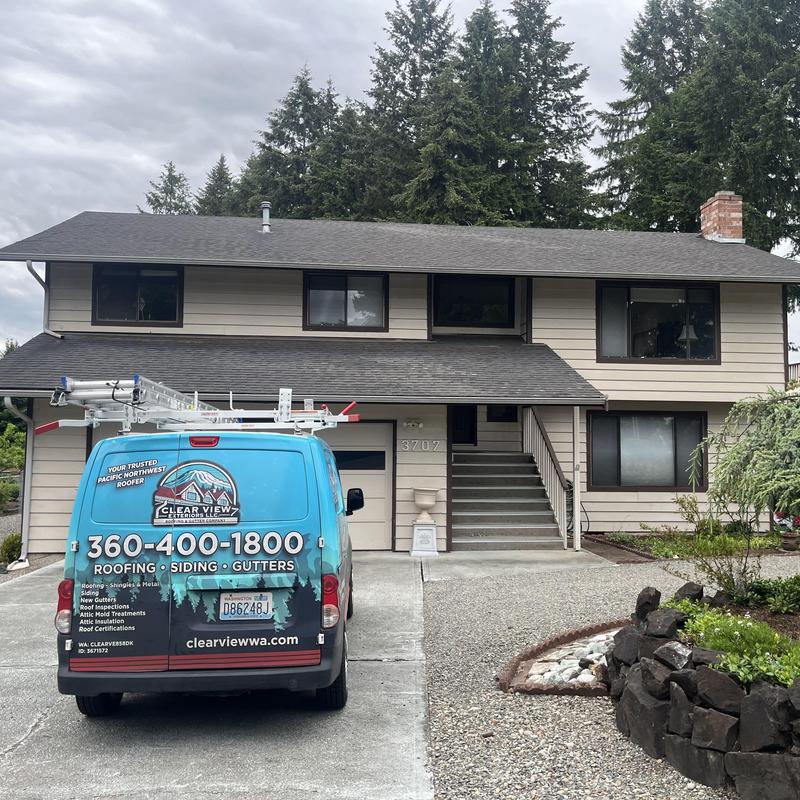 Asphalt shingle roof with roofing company van parked in driveway Asphalt shingle roof with roofing company van parked in driveway
