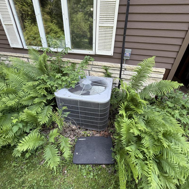Condenser fan motor in air conditioner unit outdoors Condenser fan motor in air conditioner unit outdoors