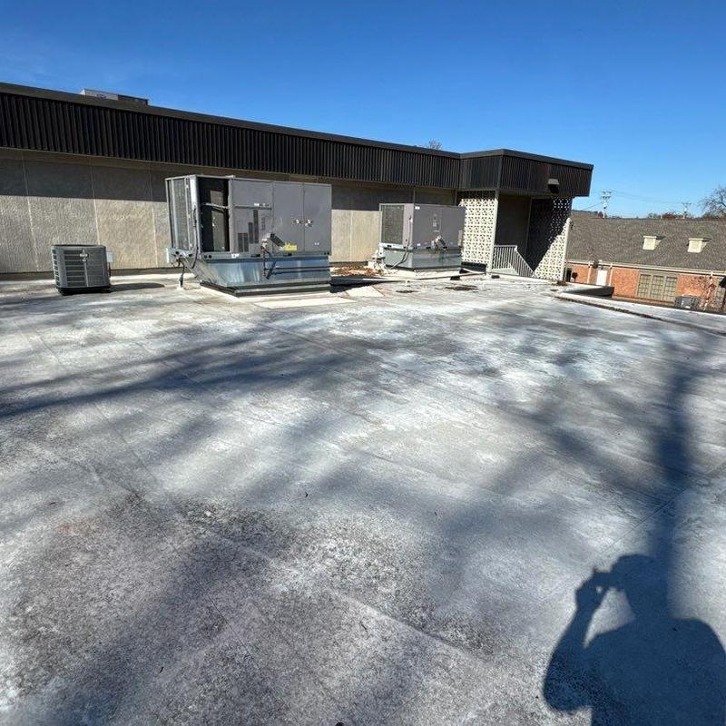 Flat roof membrane with HVAC units and damage shadows