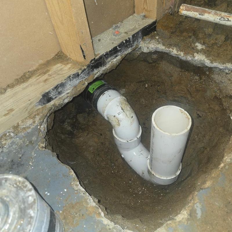 PVC floor drain pipe installation in concrete floor hole
