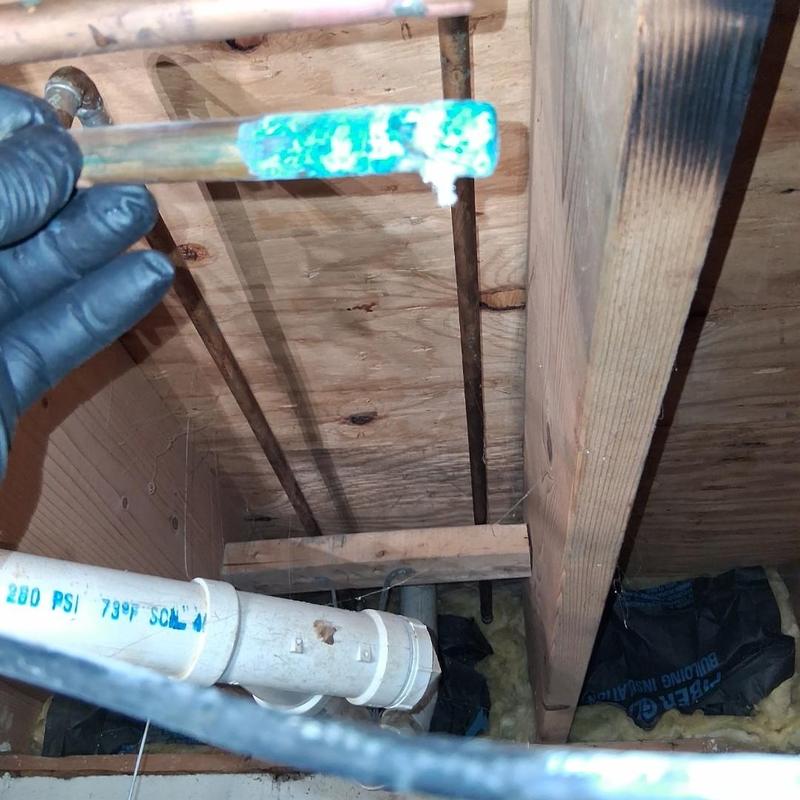 Copper plumbing pipe with corrosion and leak drip