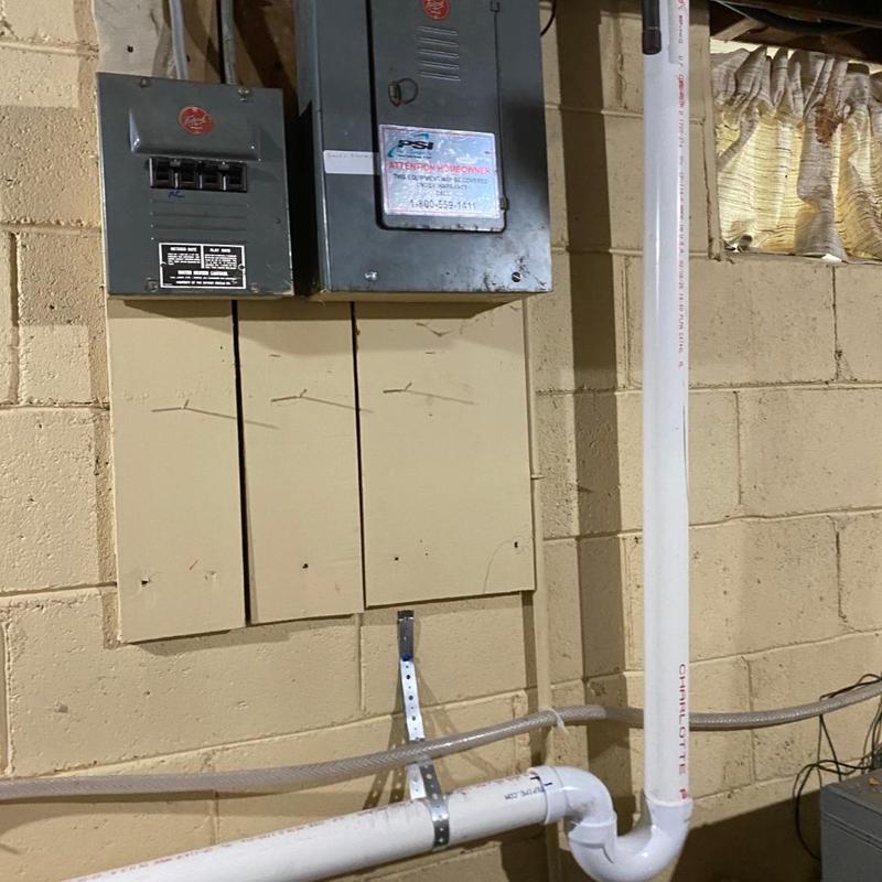 Electrical breaker panel and PVC pipe installation in basement