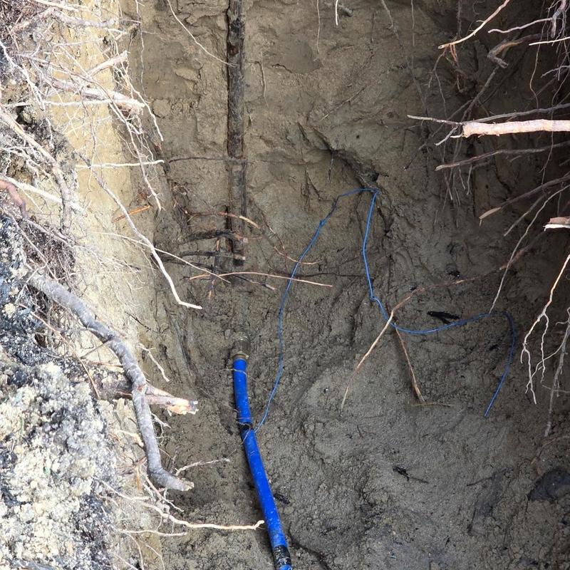 Water service line with blue pipe in trench excavation