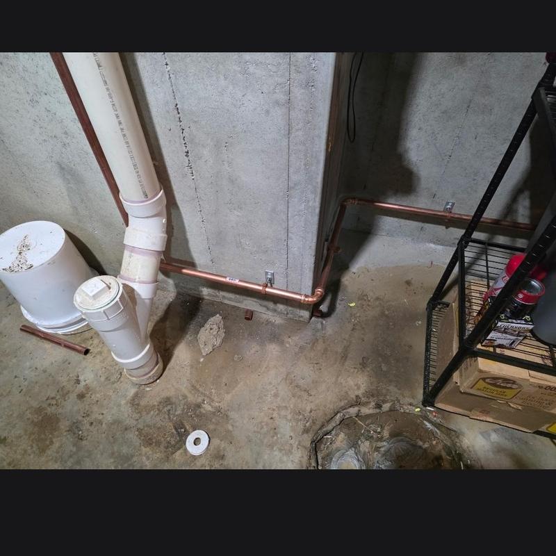 Copper water service line installed inside basement wall