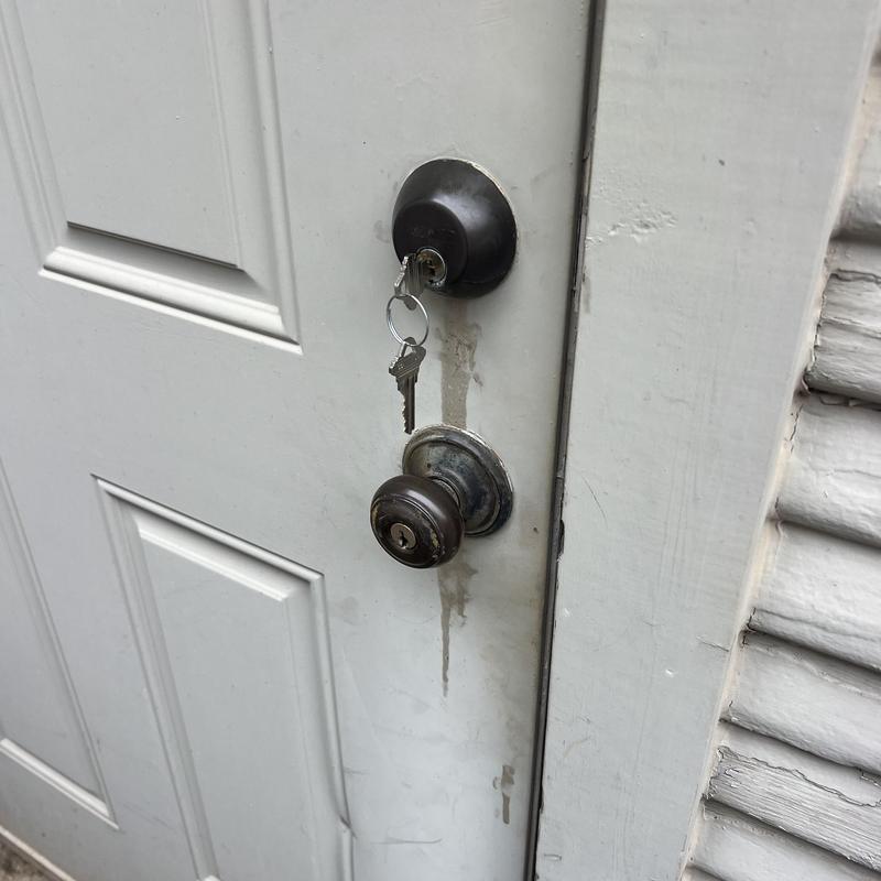 Door lock with key inserted on white residential door