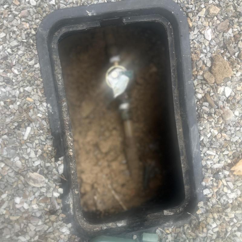 Pressure regulator box with buried piping and gravel surrounding