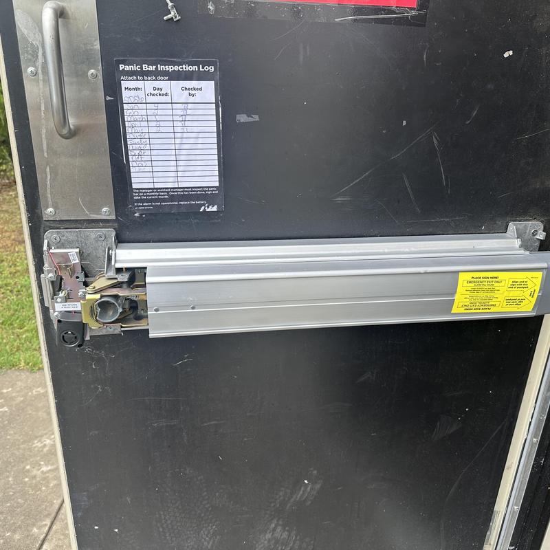 Exit device with new lock cylinder on black door Exit device with new lock cylinder on black door
