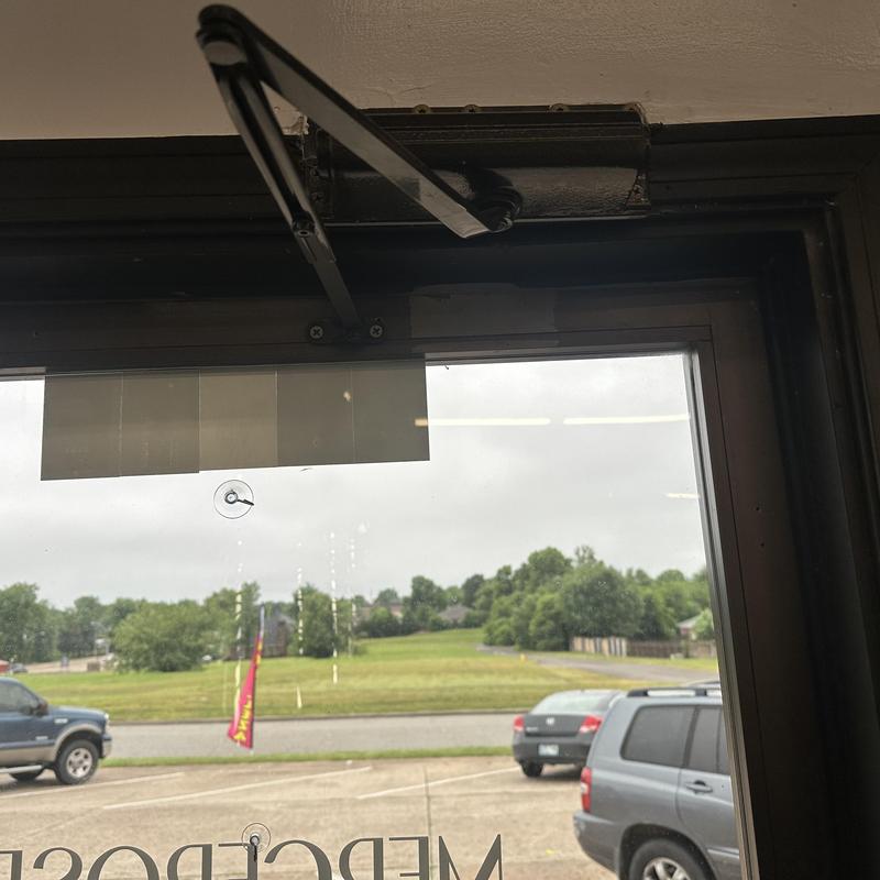 Door closer arm reattached on glass door frame