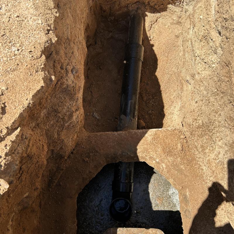 Septic tank drain line replacement and excavation site