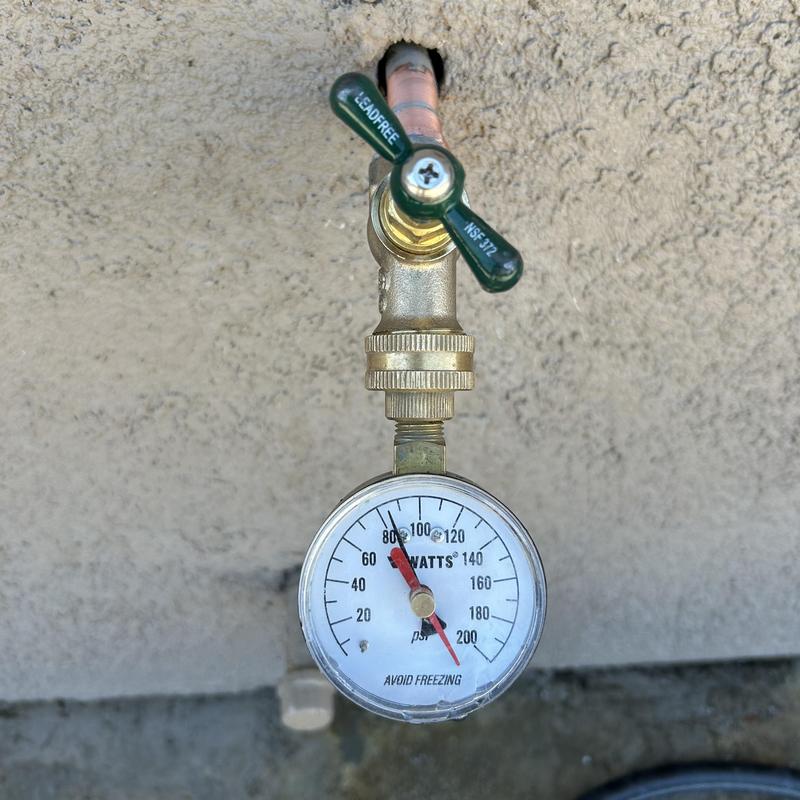 Hose bib with pressure gauge on copper pipe
