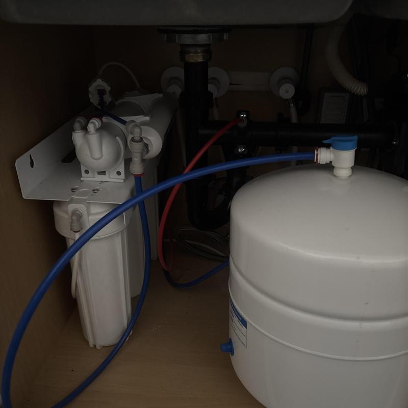 Reverse osmosis system with filters and storage tank under sink