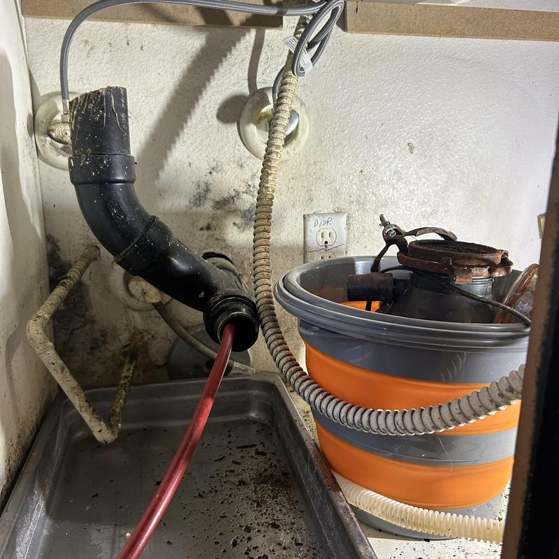 Kitchen drain with sewer snake and garbage disposal parts