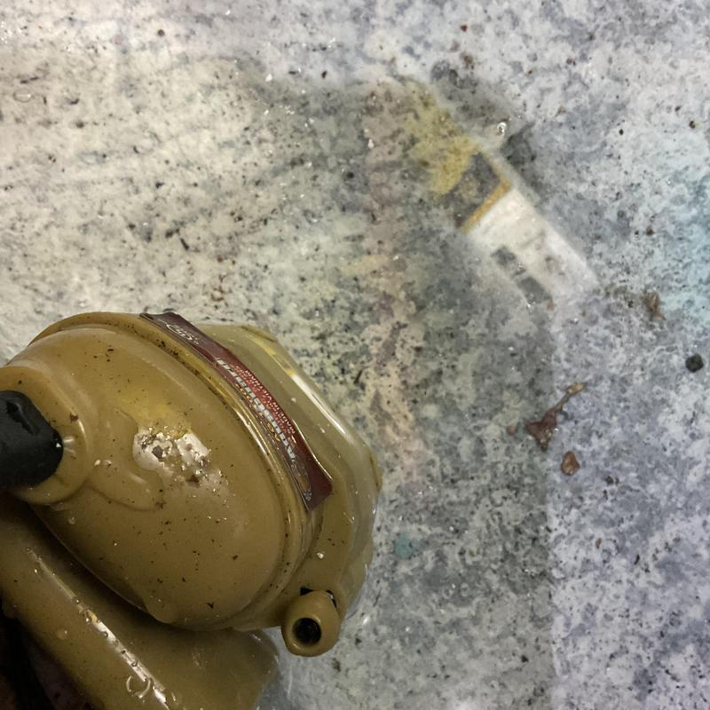 Brown HVAC compressor on wet concrete floor Brown HVAC compressor on wet concrete floor