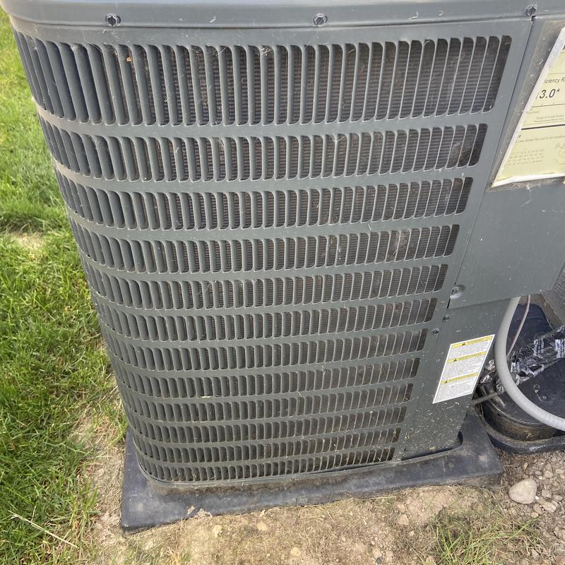 Air conditioner condenser unit exterior on ground pad