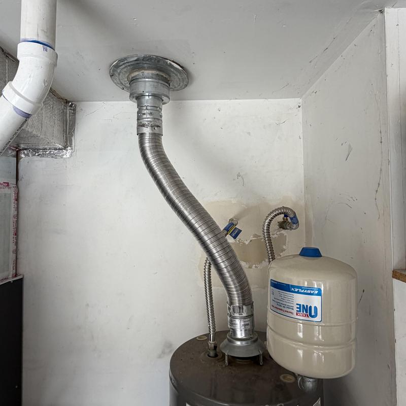 Water heater vent pipe installation with expansion tank