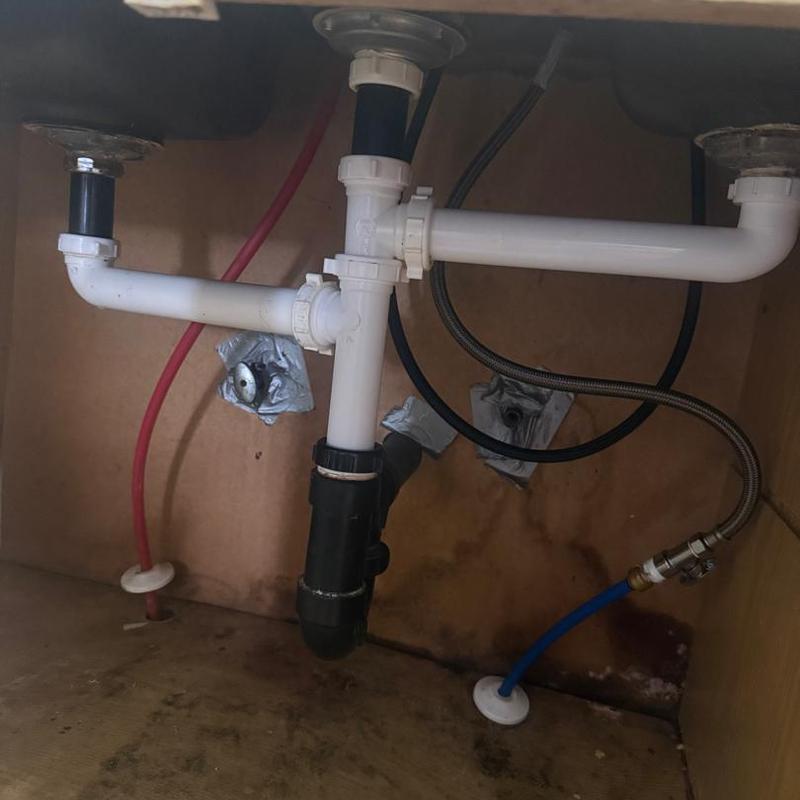 Double bowl sink traps and drain pipes under cabinet