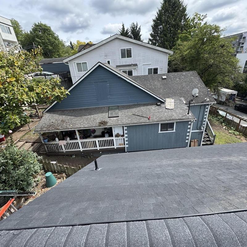 Shingle roof replacement with new black shingles