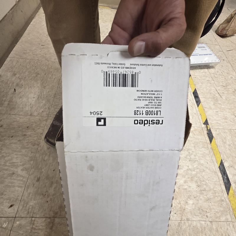 Aquastat replacement part box held by technician Aquastat replacement part box held by technician