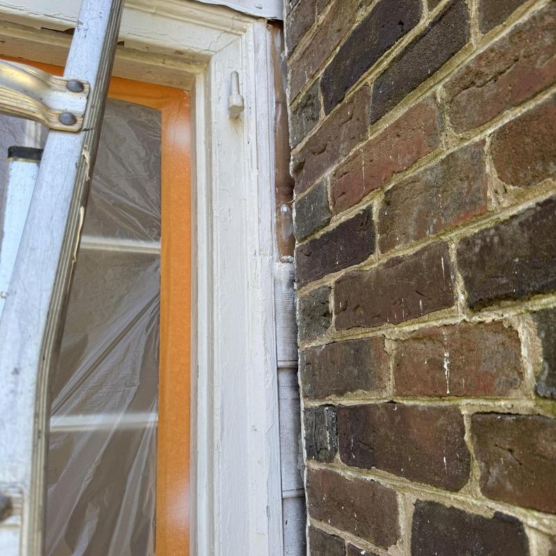 Metal flashing installation between siding and brick wall