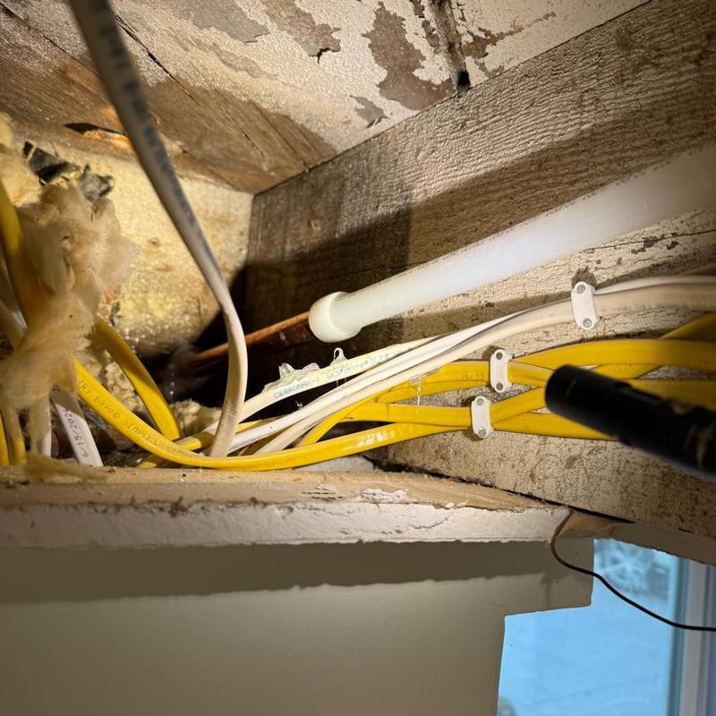 Water line installation with electrical wiring in wall cavity