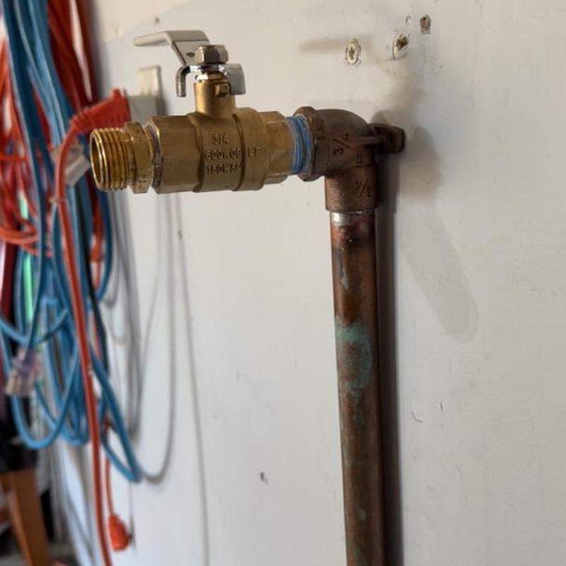 Ball valve and copper pipe spigot installation on wall
