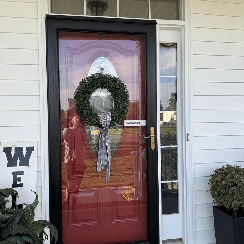 Front entry door with decorative wreath and glass panel Front entry door with decorative wreath and glass panel