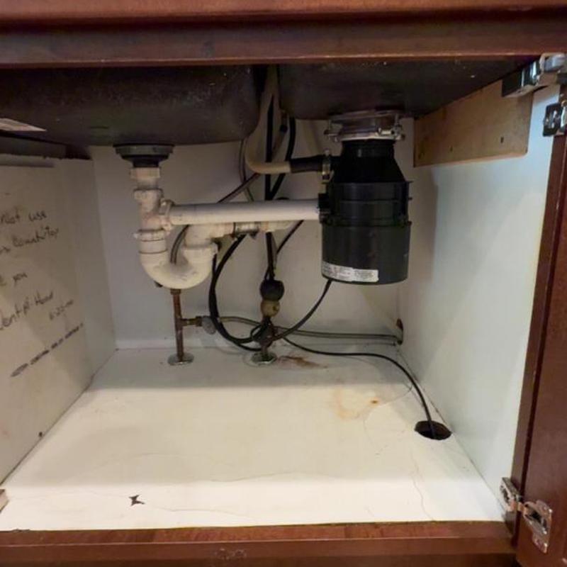 Garbage disposal and plumbing under kitchen sink