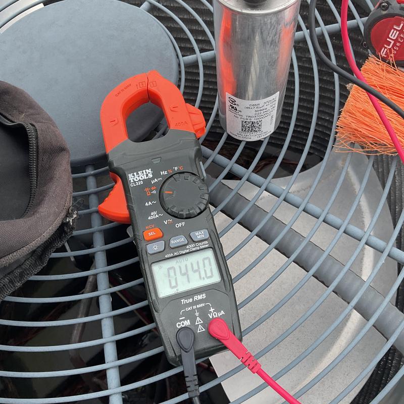 A/C unit electrical clamp meter testing on condenser fan A/C unit electrical clamp meter testing on condenser fan