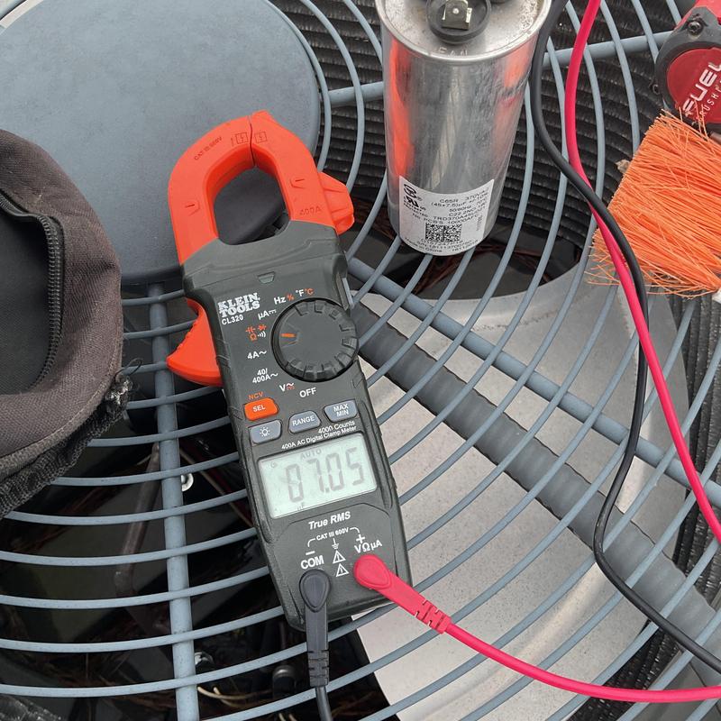 Clamp meter measuring AC condenser fan current Clamp meter measuring AC condenser fan current